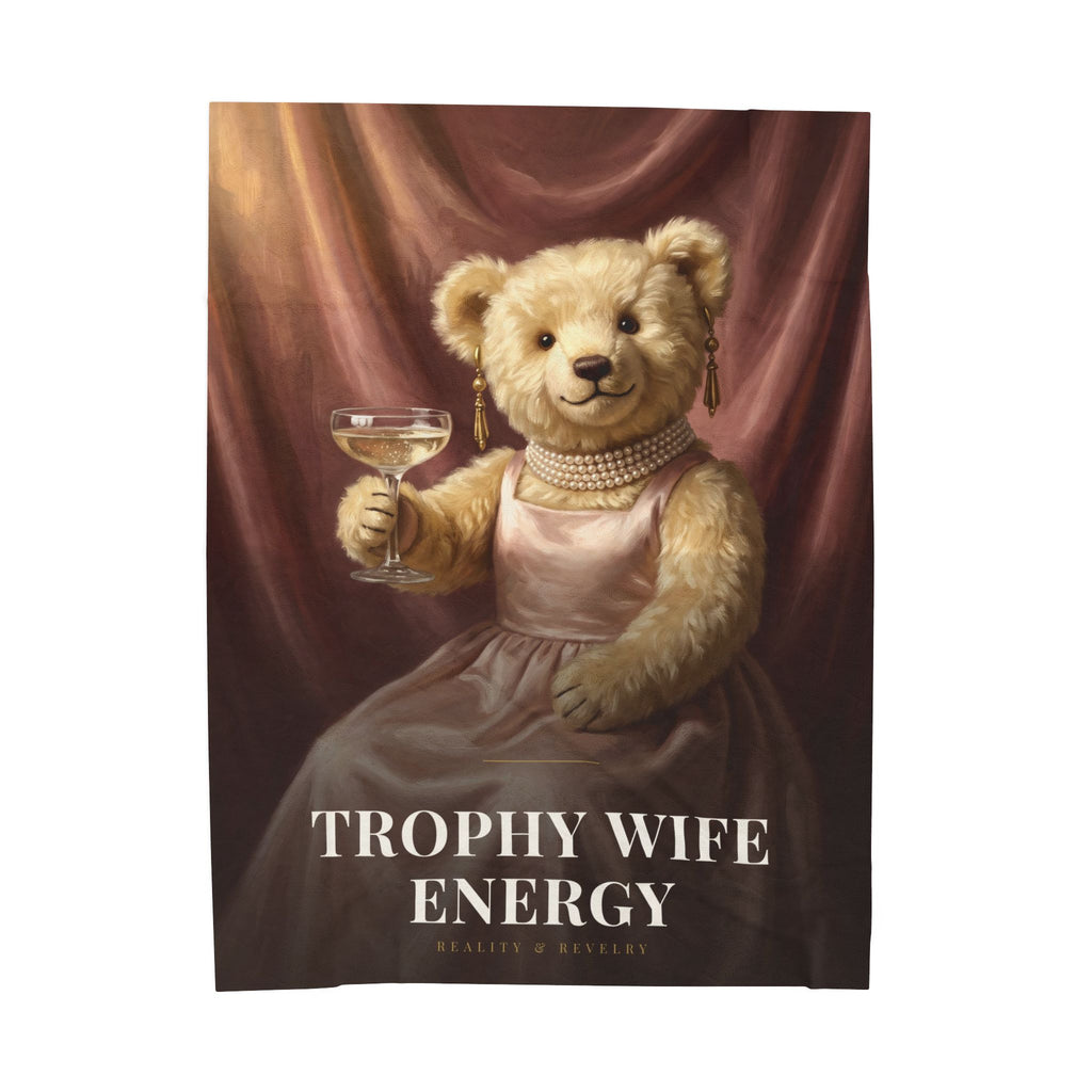 Trophy Wife Energy plush velveteen throw blanket with a painted bear in a blush satin gown holding a champagne coupe, shown at fifty by sixty inches on a bed