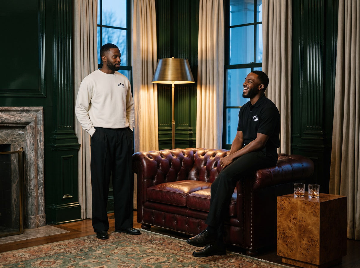 Two men in BLK on the Green polo and sweatshirt in a clubhouse library