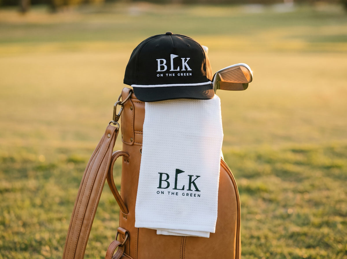 BLK on the Green Rope Cap and Caddie Towel on a tan leather golf bag