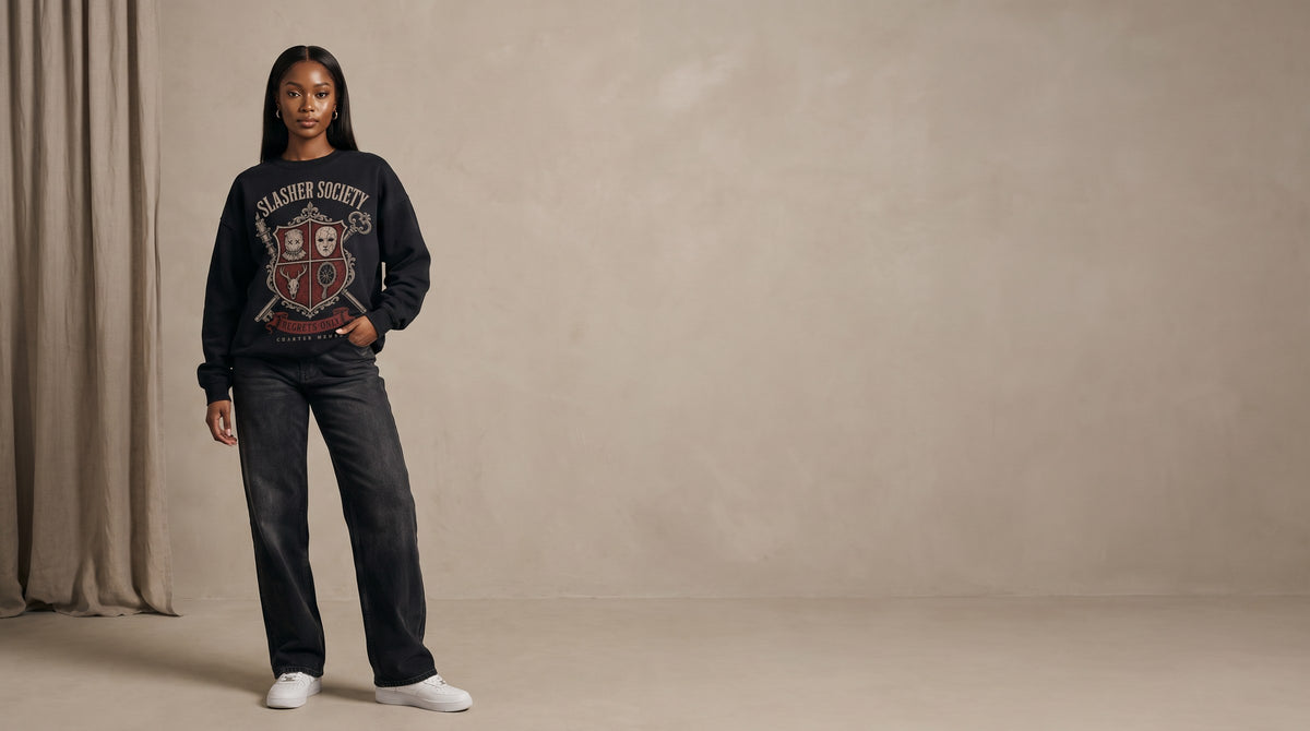 Model wearing the Slasher Society Regrets Only crewneck in a warm greige studio