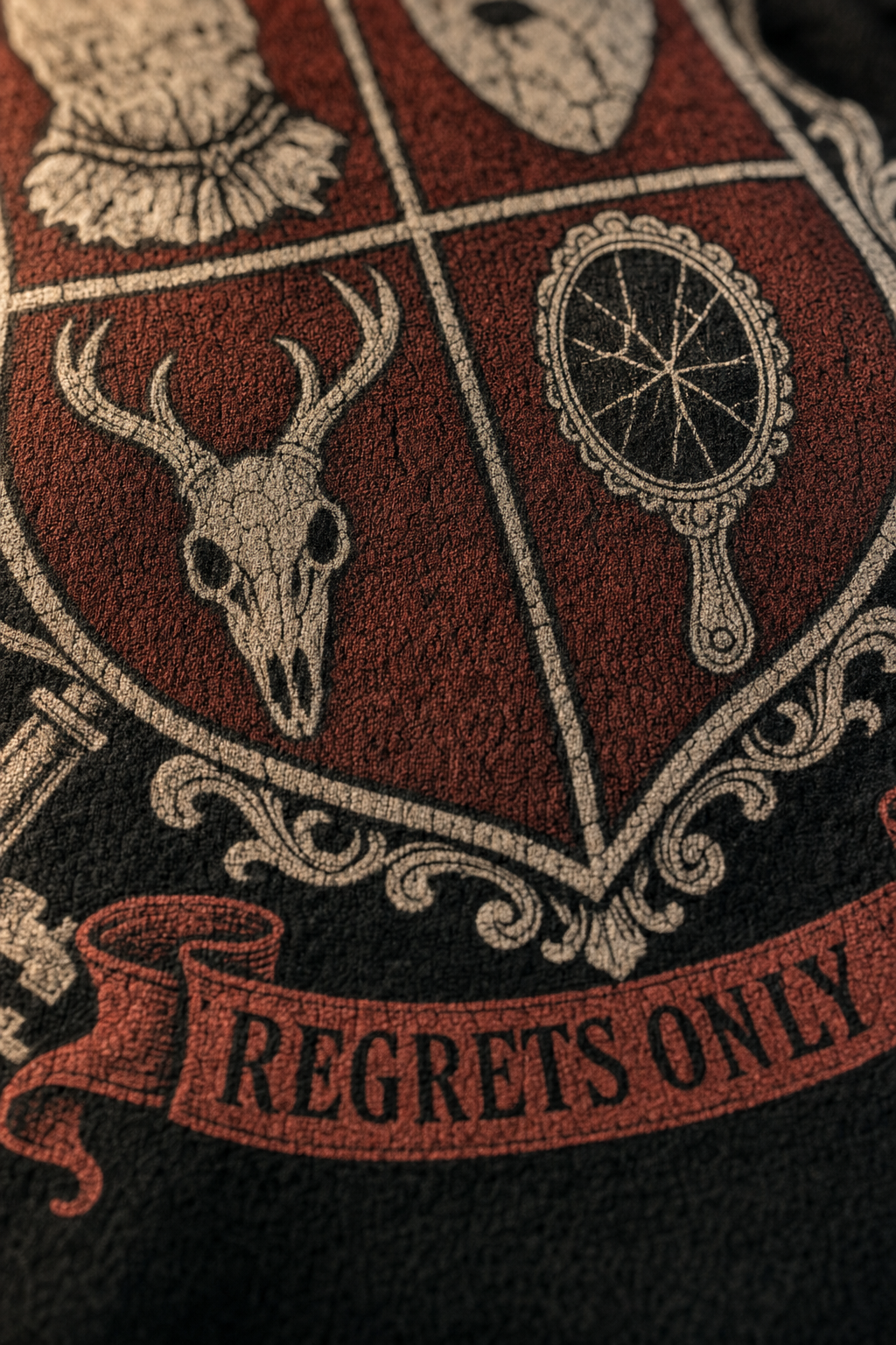 Close detail of the Slasher Society crest print on black fleece